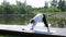 A relaxed athletic mature woman does yoga in the park, near the lake. A woman on a yoga mat to relax outdoors. An