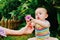 Relaxed baby enjoying the sensation of noticing the freshness of the grass on his bare feet