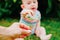 Relaxed baby enjoying the sensation of noticing the freshness of the grass on his bare feet