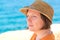 Relaxed beautiful adult caucasian woman with straw hat, head portrait