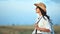 Relaxed beautiful travel backpacker woman in hat and sunglasses enjoying beauty of nature at sunset