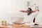 Relaxed black businessman with laptop in modern white office