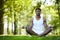 Relaxed black man meditating alone in park