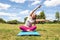 Relaxed blond woman doing yoga with bent upper body