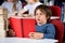 Relaxed Boy Reading Book At Table In Library