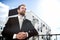 Relaxed businessman standing on balcony of his apartment