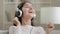 Relaxed carefree arabian young woman singer beautiful girl in headphones listening favorite music soundtrack in mp3