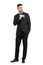 Relaxed cool handsome man in tuxedo with bow tie putting mobile phone in pocket looking away