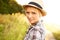 Relaxed country beauty. Beautiful young woman in a field while wearing a straw fedora.