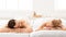 Relaxed Couple Lying On Beds Relaxing In Spa After Massage