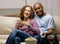 Relaxed couple with popcorn and remote control