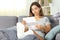 Relaxed disabled woman reading a letter at home