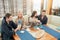 Relaxed diverse friends in bathrobes sitting at lounge zone of bathhouse