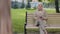 Relaxed elderly grandmother drinking coffee on park has pleasant conversation with unrecognizable companion. Mature