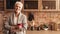 Relaxed Elderly Woman With Cup Of Coffee Posing In Kitchen