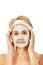Relaxed elderly woman in facial mask