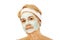 Relaxed elderly woman in facial mask