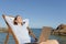 Relaxed entrepreneur resting on the beach with a laptop