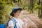 Relaxed female tourist resting in nature. Happy woman tourist with backpack. tourist girl drinking water in forest. Female with