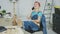 Relaxed female at workbench talking on smartphone