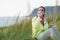 Relaxed fitness woman drinking water on workout rest