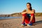 Relaxed fitness woman resting at beach