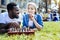 Relaxed friends enjoying chess game together