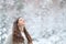 Relaxed girl breathing fresh air enjoying snow in winter