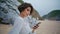 Relaxed girl browsing smartphone on sandy shore closeup. Attractive lady rest