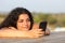 Relaxed girl watching social media in smart phone