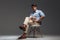 Relaxed handsome man in blue shirt sitting on the chair