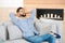 Relaxed handsome young man with laptop on sofa. Taking break during work