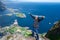 Relaxed happy hiker enjoys stunning views on Reinebringen peaks of Lofoten islands, fjords, Norway