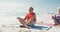 Relaxed hispanic senior couple practicing yoga on mats on beach