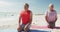 Relaxed hispanic senior couple practicing yoga on mats on beach