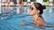 Relaxed holiday person with tan skin smiling float in poolside at beach resort close-up