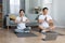 Relaxed korean couple meditating together at home