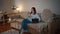 Relaxed lady browsing smartphone at evening sofa interior. Woman looking tablet