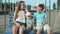 Relaxed little kids sitting on swing. Cute three siblings spending time outdoors