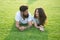 Relaxed and in love. Couple relaxing on grass enjoying each other. Man bearded hipster and pretty woman in love. Summer