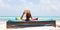 Relaxed man reading book in luxury lounger enjoying summer vacations on beautiful beach.