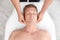 Relaxed man receiving head massage