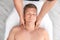 Relaxed man receiving head massage