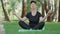 Relaxed mid-adult woman sitting in lotus pose with closed eyes. Portrait of calm Caucasian sportswoman practicing yoga