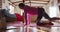 Relaxed mixed race woman practicing yoga, kneeling and stretching in sunny cottage bedroom