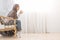 Relaxed Morning. Arab Woman Resting In Wicker Chair At Home With Coffee