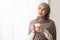 Relaxed Muslim Woman With Coffee Standing Near Window At Home