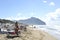 Relaxed people on the Sabaudia beach for the summer holidays. The Circeo Mountain on the background.