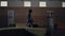 Relaxed pupil walking dark school hall alone. Teen schoolboy passing lockers.