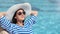 Relaxed smiling fashion female enjoying sunbathing near swimming pool having summer travel vacation